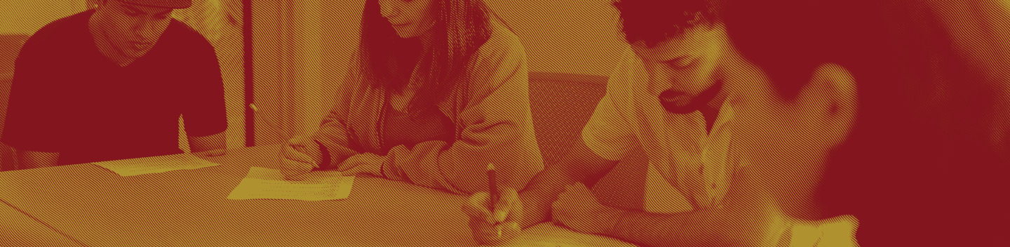 Students seated at a table working.
