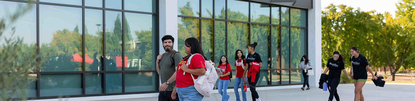 Students walking outdoors at the main campus in Turlock.