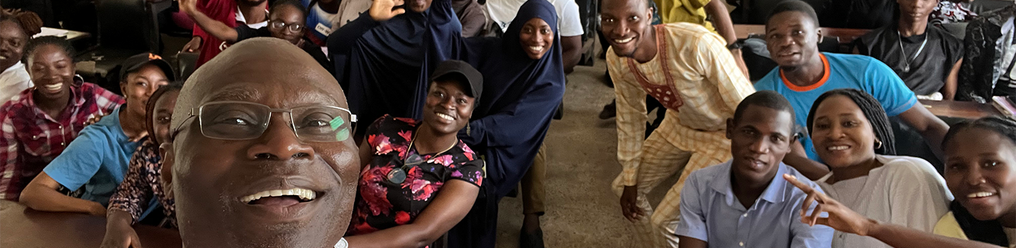 Oluwarotimi Odeh poses for a selfie with students in Nigeria.
