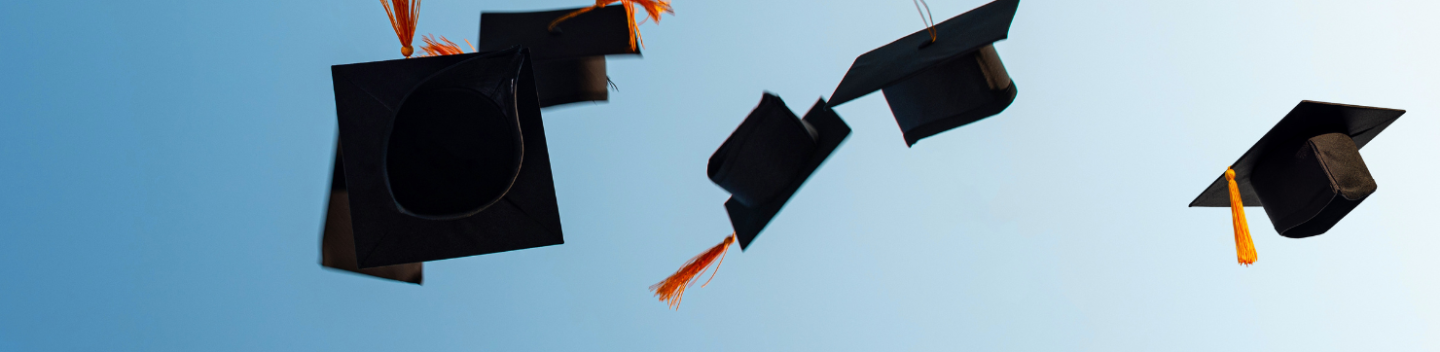 Graduation caps thrown in the air