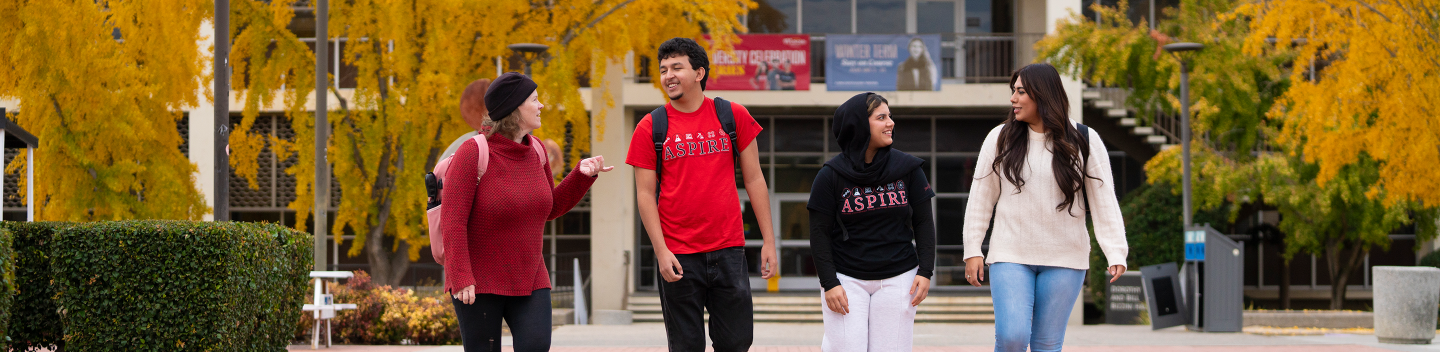 Four Stan State students walking on campus.