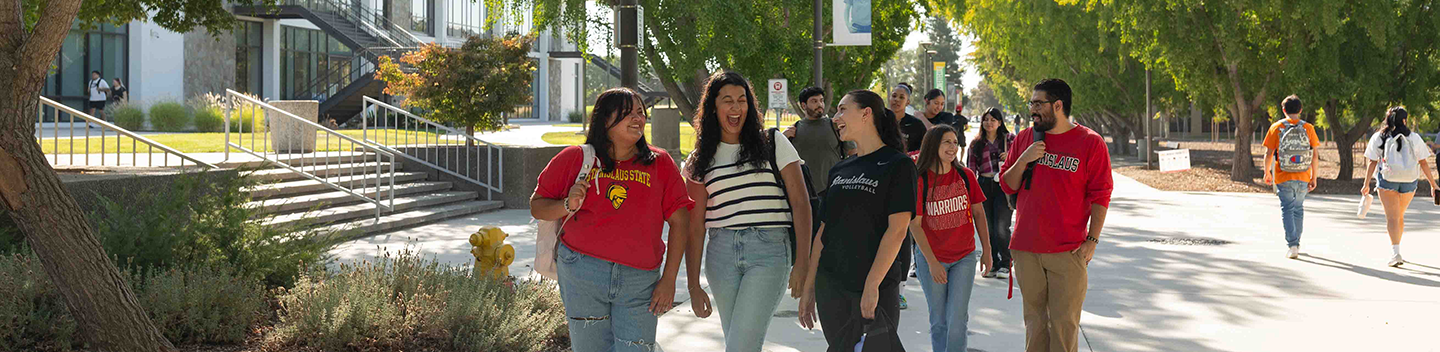 Students walking on campus outdoors.