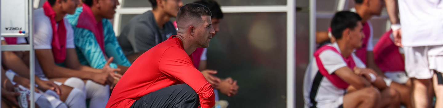 John Powell coaches his soccer players from the sideline.