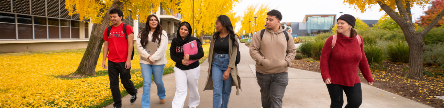 6 students walking on campus