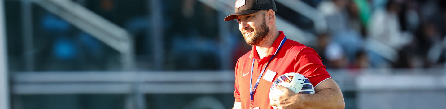 Steven Flowers holding a soccer ball.