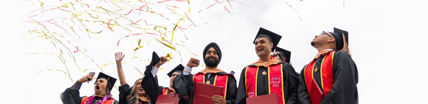 Graduates celebrating at Commencement. 