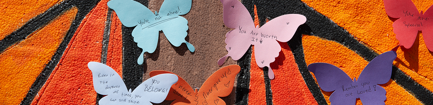 Paper butterflies with words of affirmations on them.