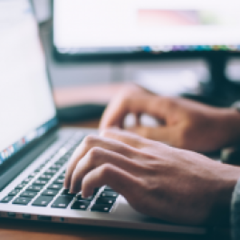 hands typing on computer keyboard