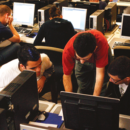 Tech students working together in computer lab.