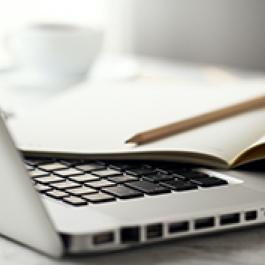Laptop, notepad, and pencil