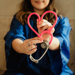 student making a heart with a stethoscope
