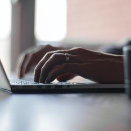 person typing on Laptop