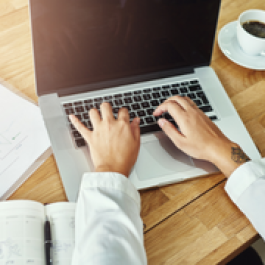 student typing on a laptop