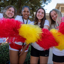 four girls waving pom poms