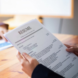A person holds a resume.