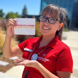 staff holding congrats on becoming a warrior card