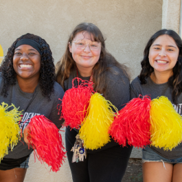 three girls with pom poms