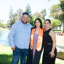 Family photo with a female student at college graduation.