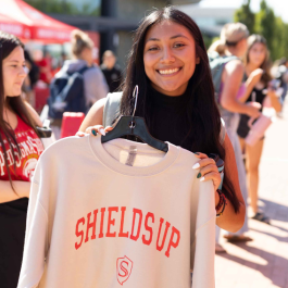 Student with a Stan State Shields Up Sweatshirt