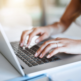 Student typing on laptop