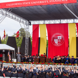 A full commencement stage with faculty and students