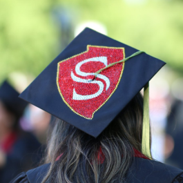 A graduation cap adorned with the Stan State logo in gems