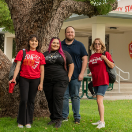 Four students stand at the front of the Stockton Campus