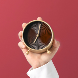 Hand holding a clock