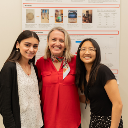 Dr. Schara with two students at a research conference