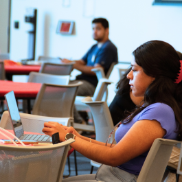 A student is seen working on a laptop