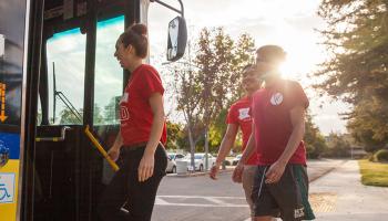 Students walking onto a bus