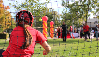 Softball player catching a ball at an admissions event