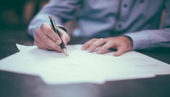 Man writing on documents.