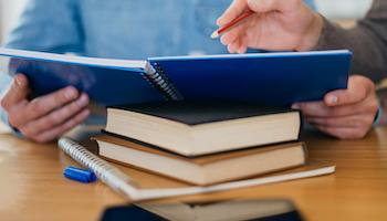 High angle of individual holding notebook