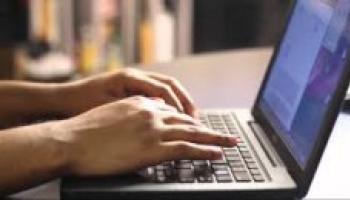 Person typing on laptop.