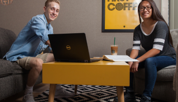 male and female student studying on laptop