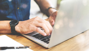 person typing on a laptop keyboard