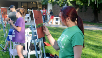 Students painting on canvas.