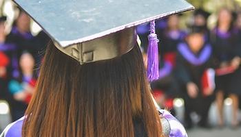 Close up image of a student graduating. 