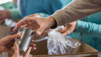 Volunteers preparing various food boxes.