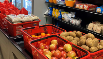 Photo of Inside of Turlock Food Pantry. Includes images of produce, shelving with food and toiletries, and fridge and freezer. 