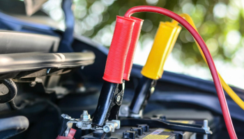 A vehicle with jumper cables attached to its battery.