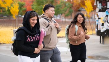 Three students walking on campus