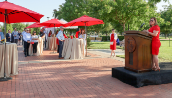 An audience is gathered at the University Quad at Stan State