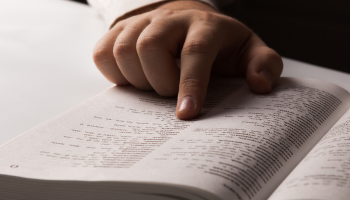 A hand points at a term in a glossary