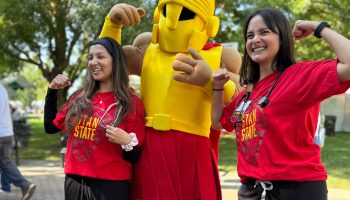 Two students pose for a picture with Titus the Warrior