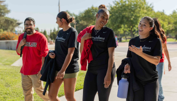 Group of students walking on campus in school swag