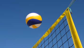 Volleyball being passed across field.