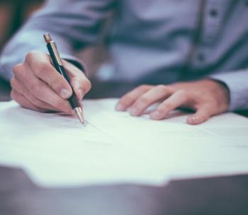 Man writing on documents.
