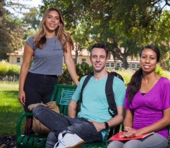 Three students in a group photo.